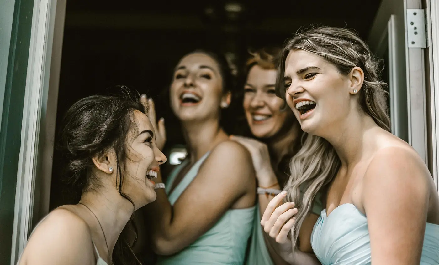 Bridesmaids laughing on wedding day